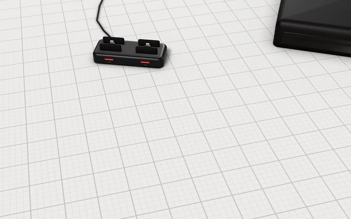 Illustration of the 5 PS3 controllers to scale, next to a slim disc console and a charging dock for size
